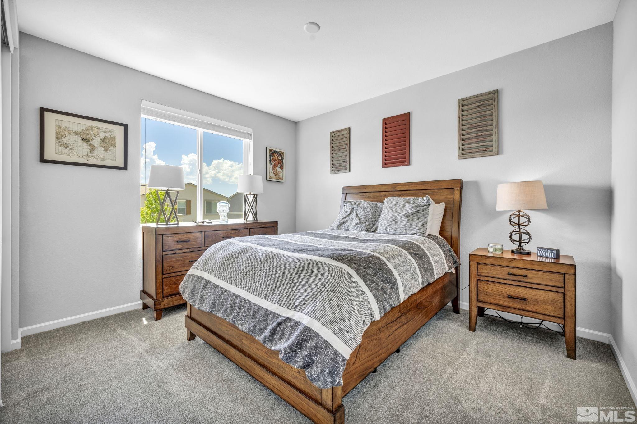 2265 Selway Drive Sparks, NV 89436 - Photo 28 of 39 a bed sitting in a bedroom and lamp next to a window
