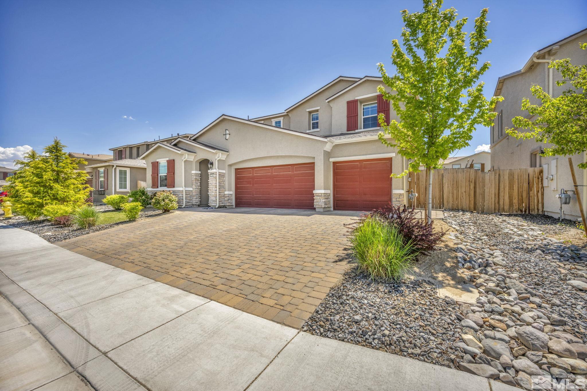 2265 Selway Drive Sparks, NV 89436 - Photo 3 of 39 a front view of a house with a yard and garage