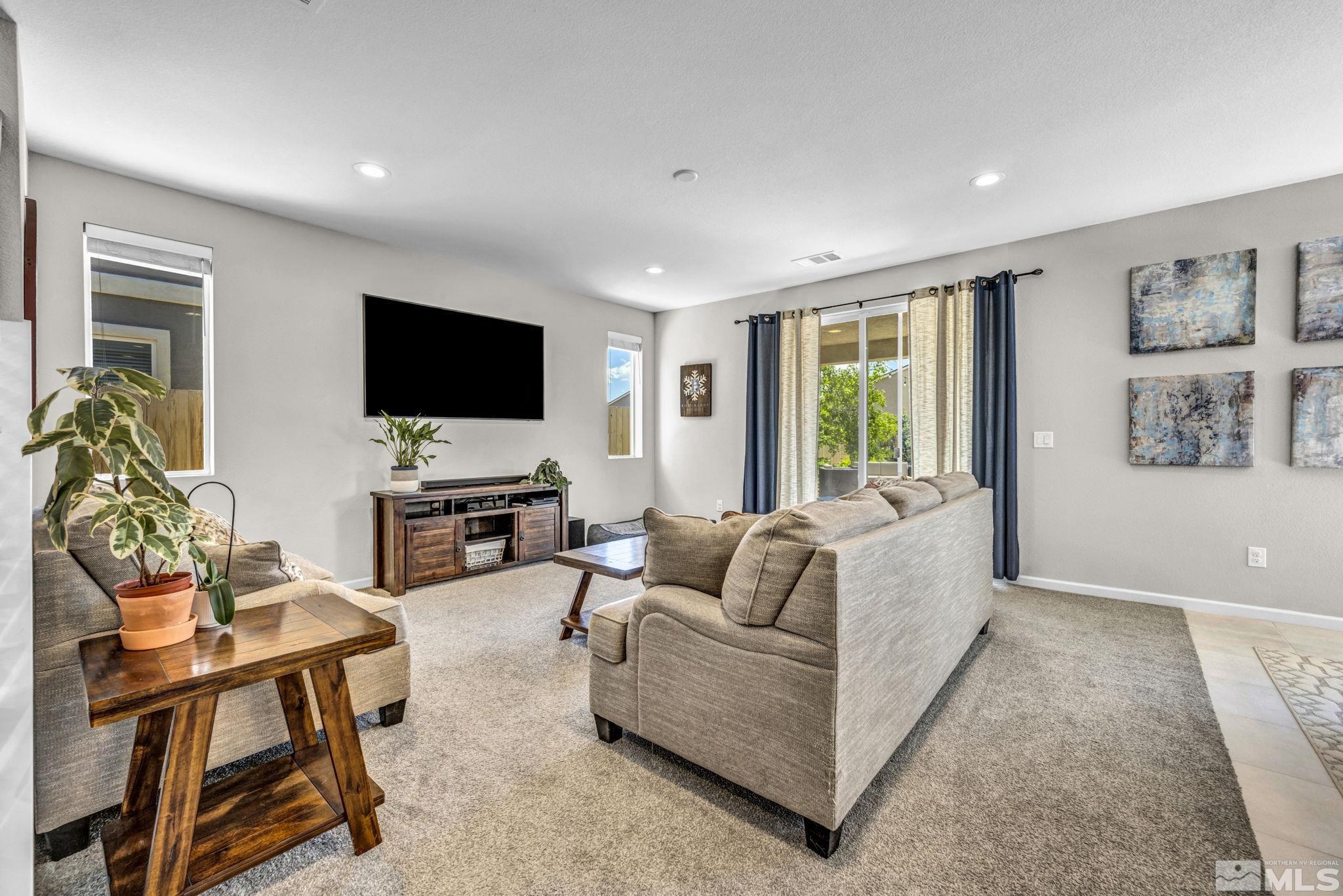 2265 Selway Drive Sparks, NV 89436 - Photo 4 of 39 a living room with furniture a flat screen tv and a large window