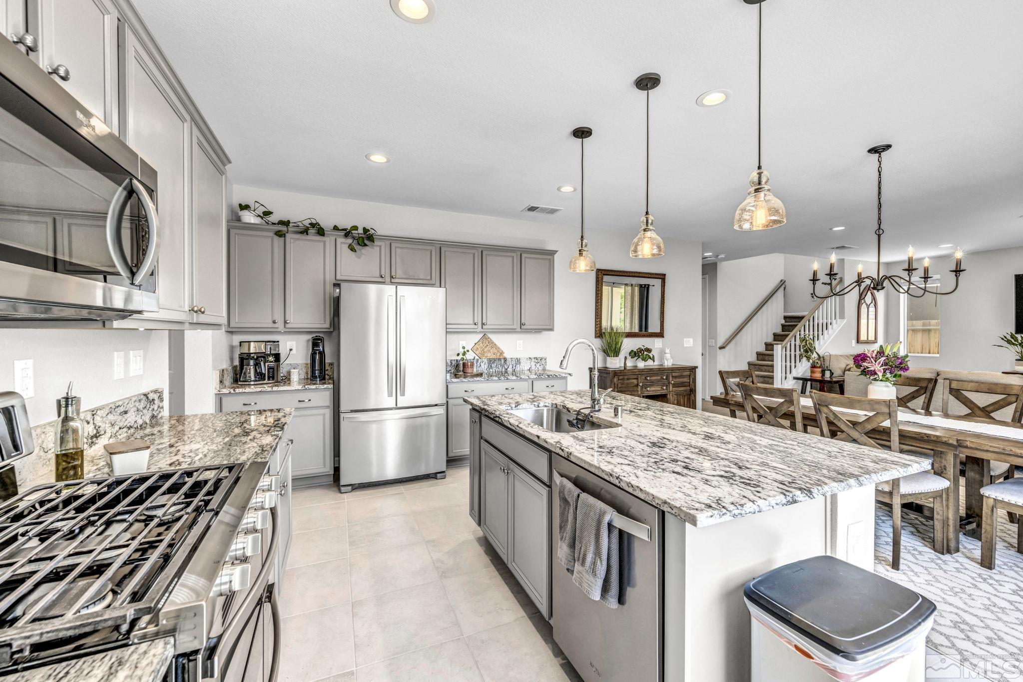 2265 Selway Drive Sparks, NV 89436 - Photo 8 of 39 a kitchen with stainless steel appliances granite countertop a stove oven and a refrigerator