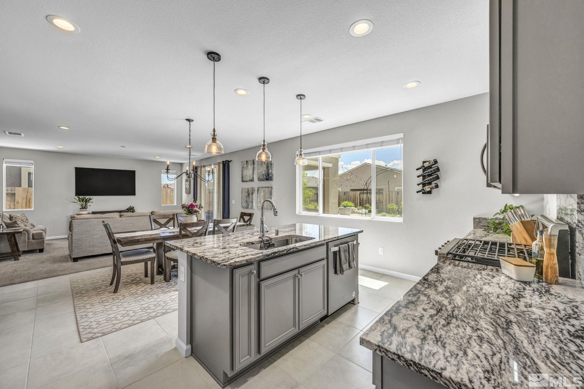2265 Selway Drive Sparks, NV 89436 - Photo 10 of 39 a open kitchen with stainless steel appliances granite countertop a stove and a sink