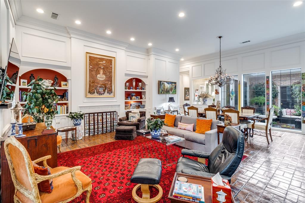 5723 Overdowns Drive Dallas, TX 75230 - Photo 11 of 36 a living room with furniture a rug and a chandelier