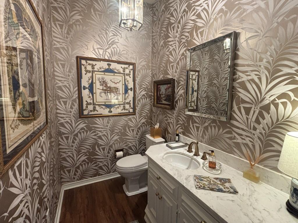 5723 Overdowns Drive Dallas, TX 75230 - Photo 19 of 36 a bathroom with a granite countertop toilet a sink and mirror