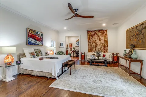 a bedroom with furniture and a large mirror