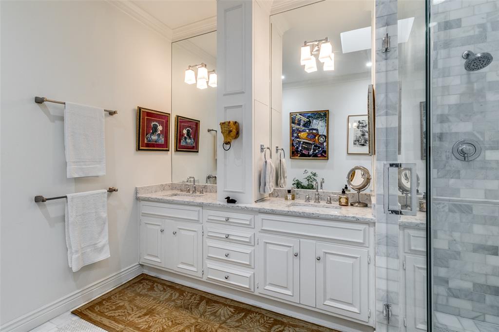 5723 Overdowns Drive Dallas, TX 75230 - Photo 22 of 36 a bathroom with a sink and a mirror