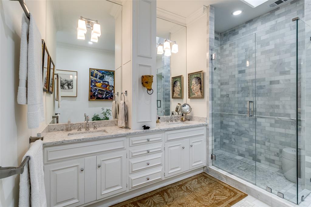5723 Overdowns Drive Dallas, TX 75230 - Photo 23 of 36 a bathroom with a sink a vanity and a mirror