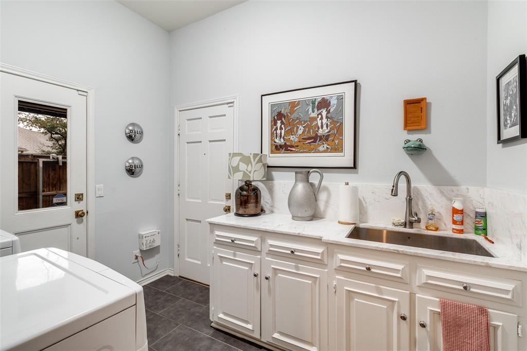 5723 Overdowns Drive Dallas, TX 75230 - Photo 29 of 36 a view of cabinets with sink and wooden floor