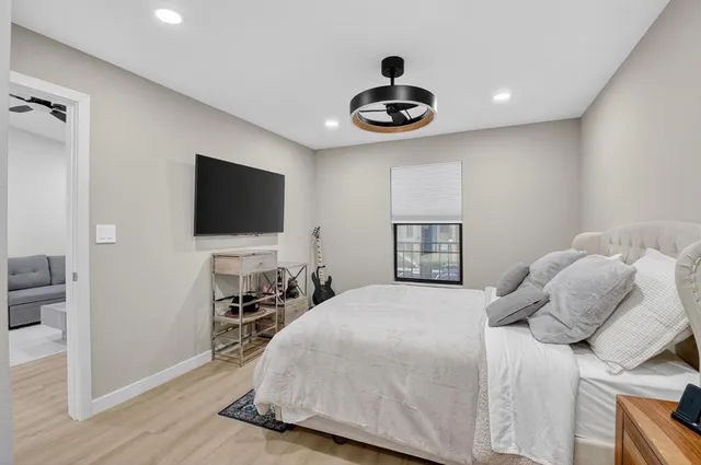 a bedroom with a bed and a flat screen tv