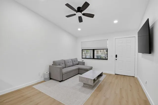 a kitchen with a sink cabinets and wooden floor