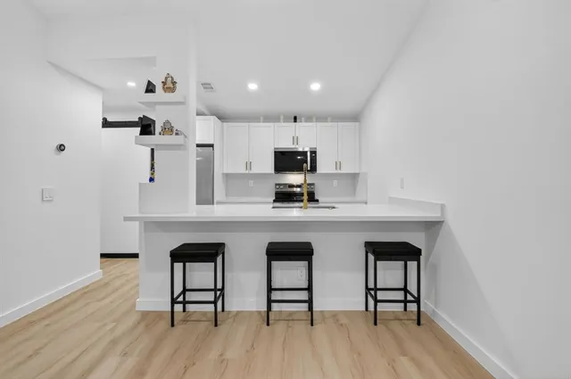 a kitchen with a sink stove and microwave