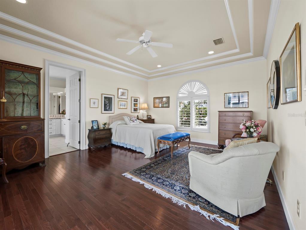 573 Spinnaker Lane Longboat Key, FL 34228 - Photo 11 of 43 a living room with furniture chandelier and a fireplace