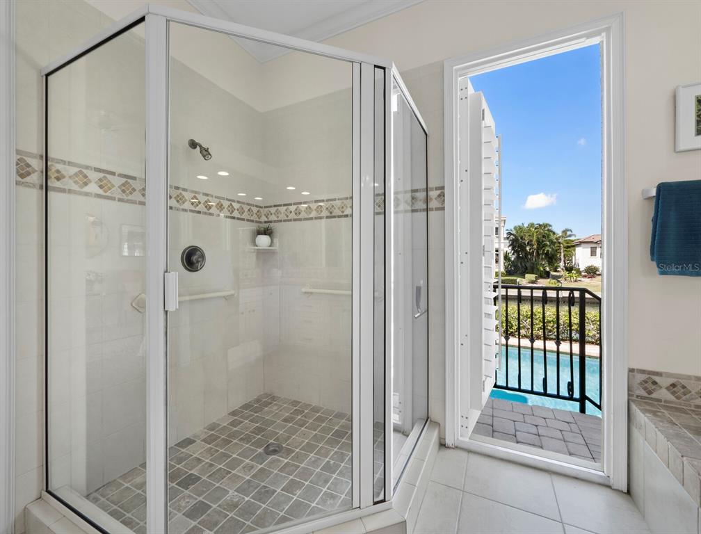 573 Spinnaker Lane Longboat Key, FL 34228 - Photo 14 of 43 a bathroom with a glass shower door