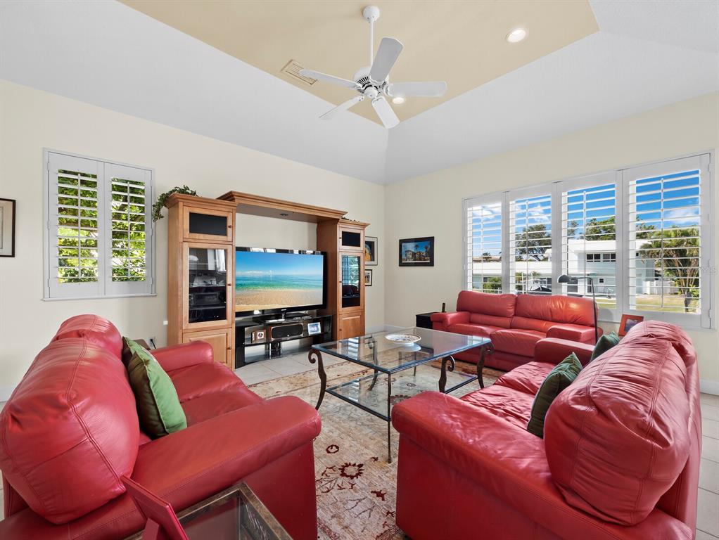 573 Spinnaker Lane Longboat Key, FL 34228 - Photo 17 of 43 a living room with furniture and a flat screen tv