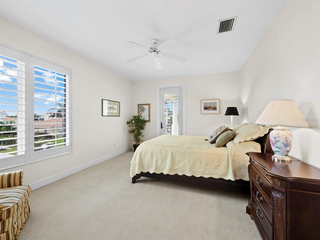 573 Spinnaker Lane Longboat Key, FL 34228 - Photo 20 of 43 a spacious bedroom with a bed and a window