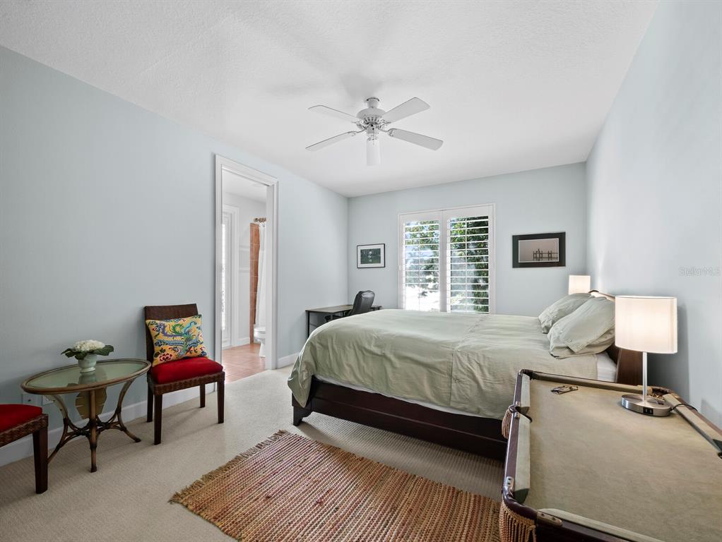 573 Spinnaker Lane Longboat Key, FL 34228 - Photo 22 of 43 a bedroom with a bed and wooden floor