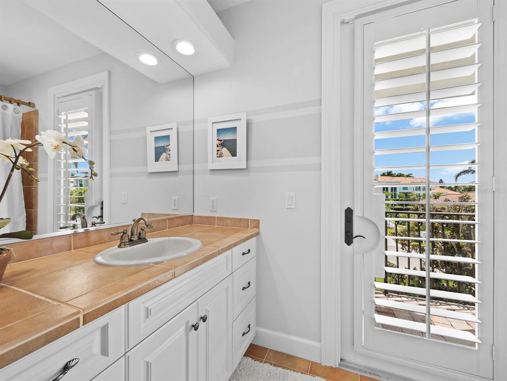 573 Spinnaker Lane Longboat Key, FL 34228 - Photo 23 of 43 a bathroom with a sink double vanity and a shower