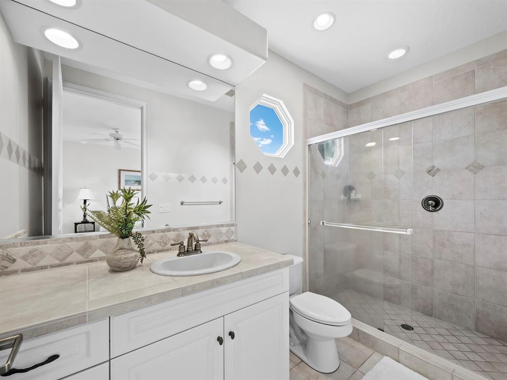 573 Spinnaker Lane Longboat Key, FL 34228 - Photo 28 of 43 a bathroom with a sink toilet and shower