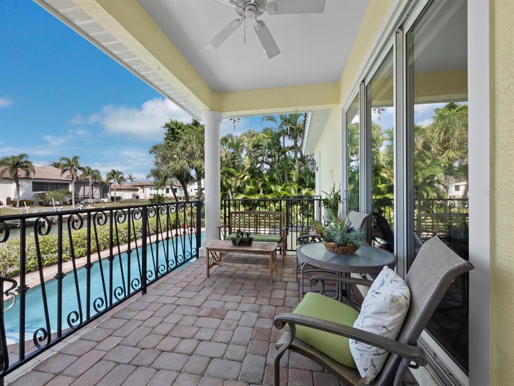 573 Spinnaker Lane Longboat Key, FL 34228 - Photo 8 of 43 a balcony with furniture and a potted plant