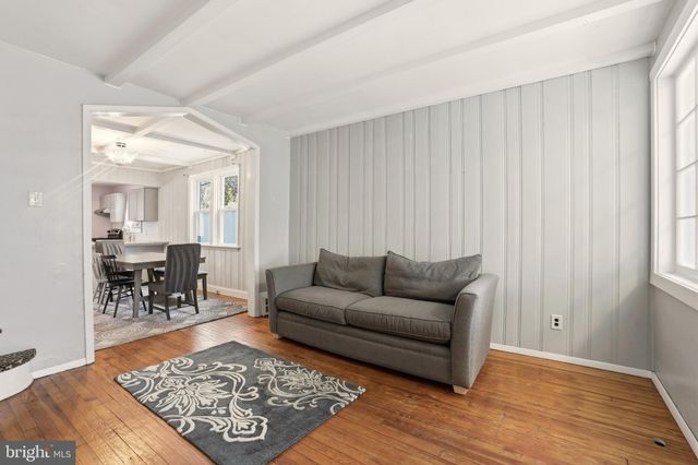 a living room with furniture rug and a table