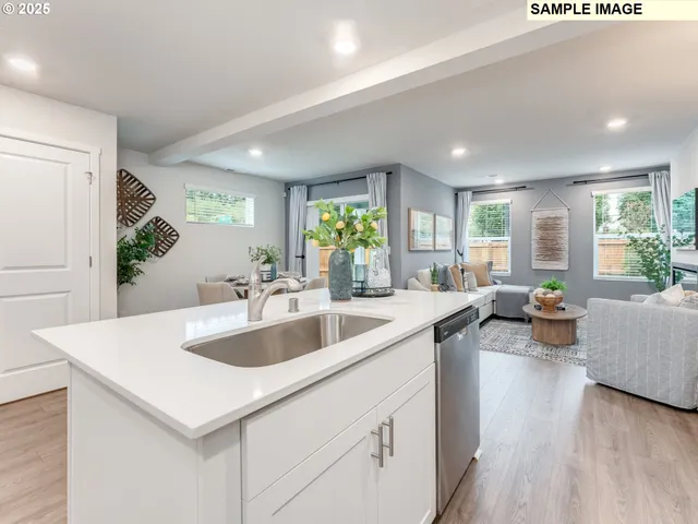 a view of kitchen island a sink and living room with couches