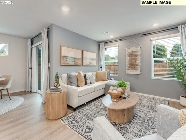 a living room with furniture and a potted plant