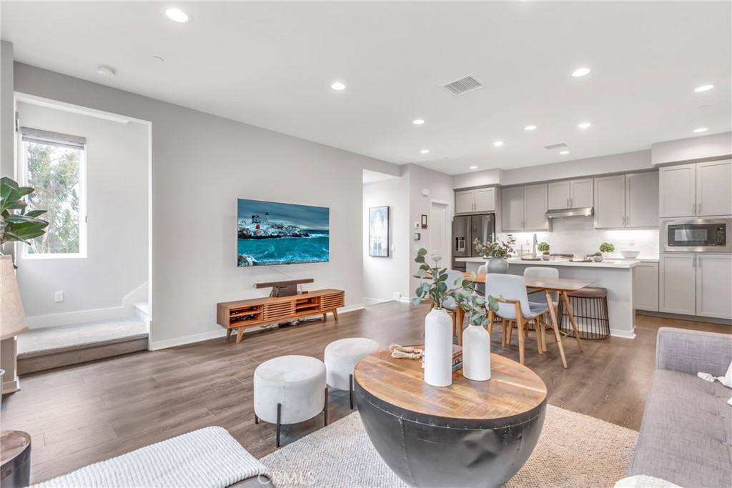 a living room with furniture and a wooden floor