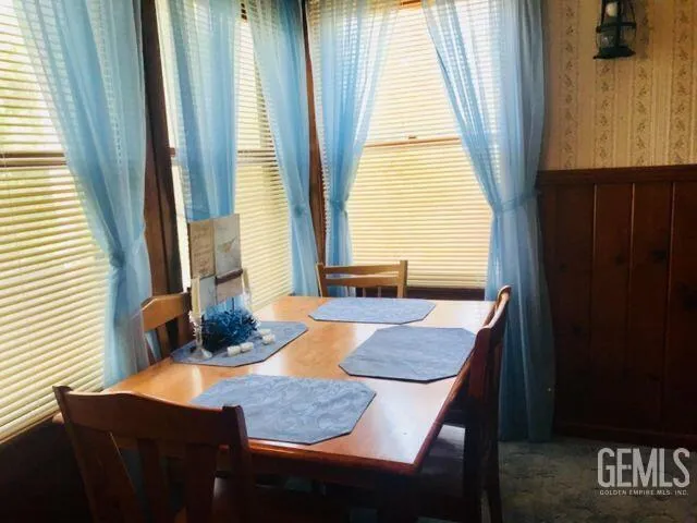 a dining room with table and chairs