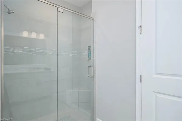 a bathroom with a glass shower door