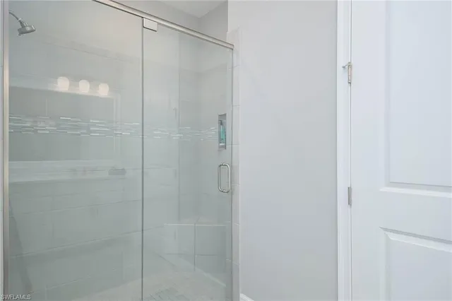 a bathroom with a glass shower door