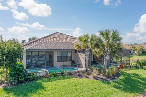 a front view of a house with a garden and plants