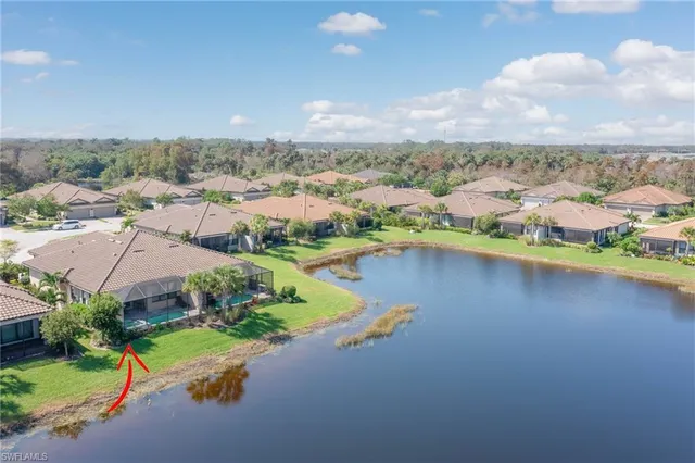 an aerial view of residential houses with outdoor space and river