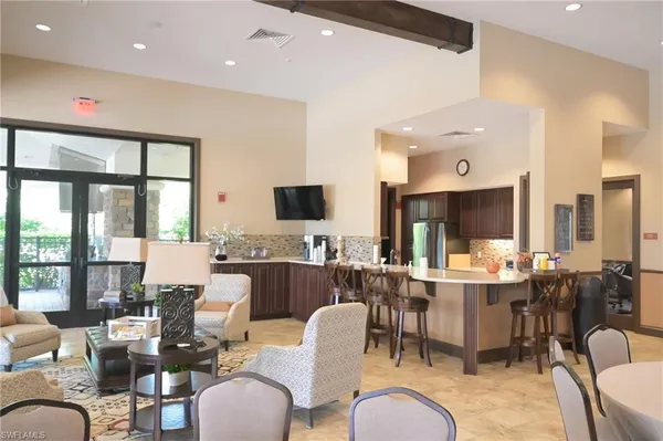 a large kitchen with a table and chairs