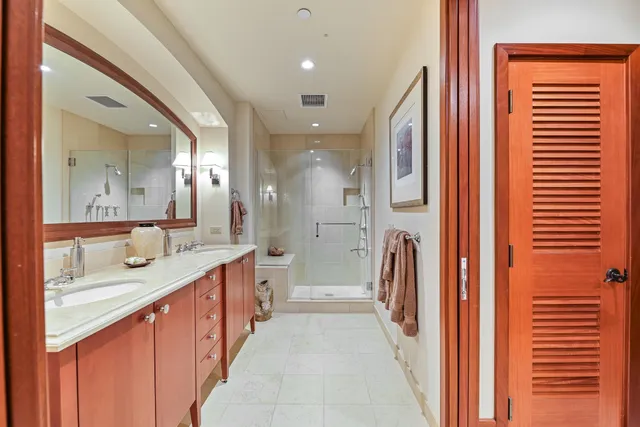 a large bathroom with a glass door shower and sink