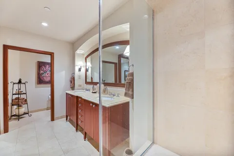 a bedroom with a bed chair and a potted plant