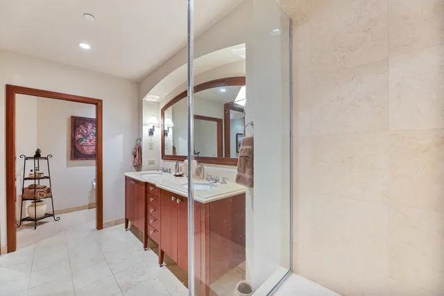 a bedroom with a bed chair and a potted plant