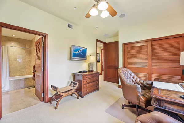 a bedroom with a bed and a bookshelf