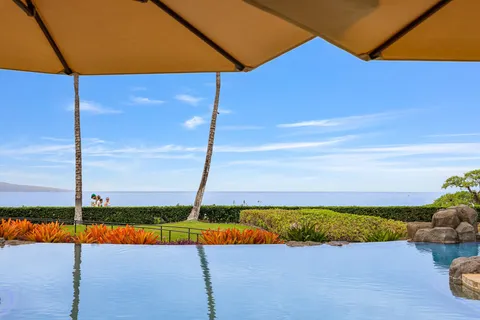 a swimming pool with outdoor seating and yard