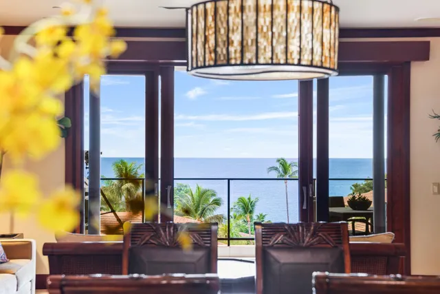 a view of a balcony with wooden floor and a floor to ceiling window