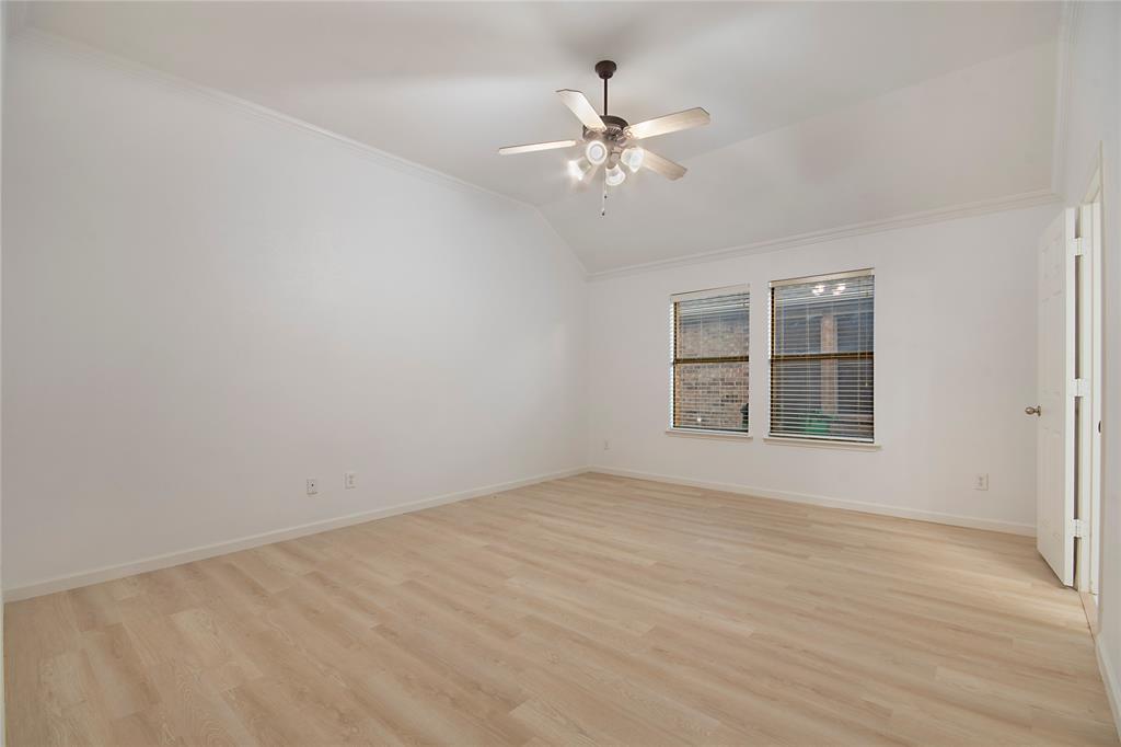 549 Hickory Lane Fate, TX 75087 - Photo 18 of 38 Spare room with light wood-style flooring, ceiling fan, crown molding, and lofted ceiling