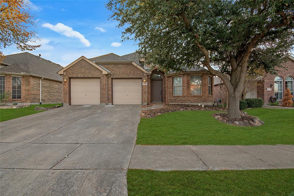 549 Hickory Lane Fate, TX 75087 - Photo 2 of 38 View of front of home with brick siding, driveway, a front lawn, and a garage