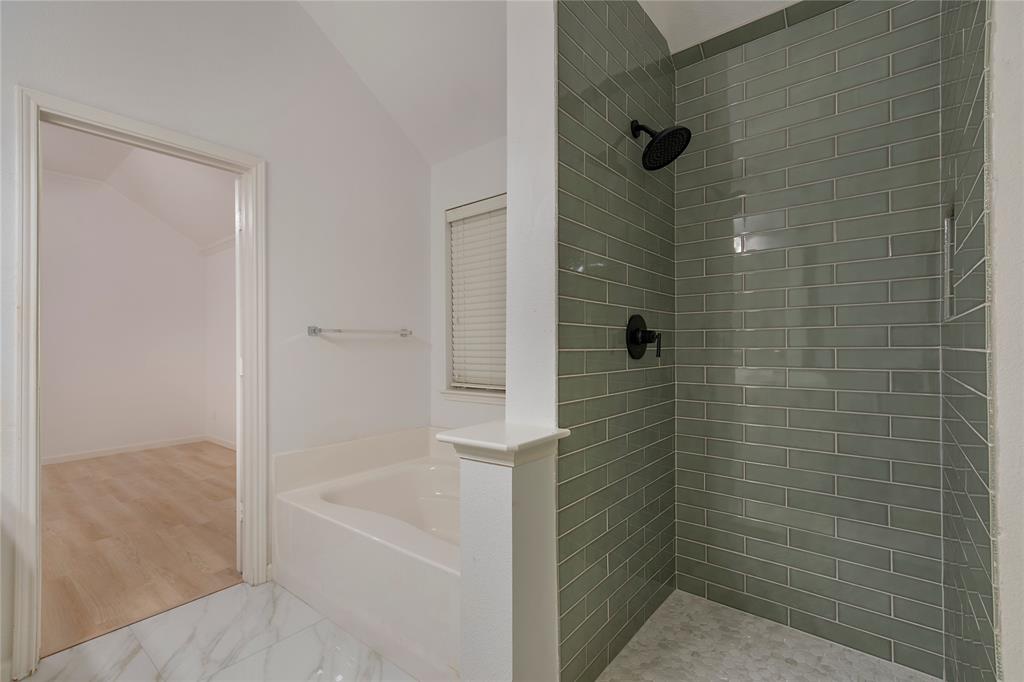 549 Hickory Lane Fate, TX 75087 - Photo 22 of 38 Full bath featuring a garden tub, a shower stall, lofted ceiling, and light marble finish flooring