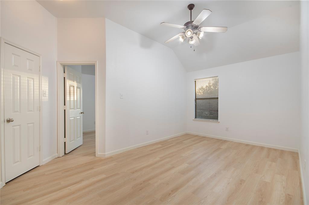 549 Hickory Lane Fate, TX 75087 - Photo 24 of 38 Unfurnished bedroom featuring light wood-style flooring, vaulted ceiling, and a ceiling fan