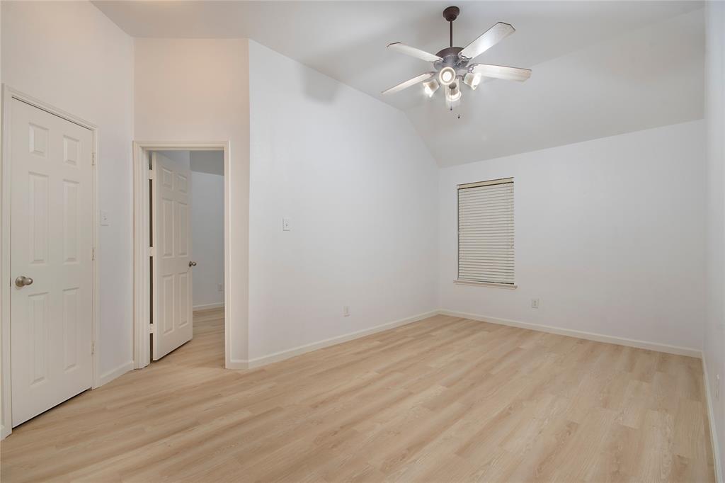 549 Hickory Lane Fate, TX 75087 - Photo 25 of 38 Unfurnished bedroom with light wood-style floors, vaulted ceiling, and a ceiling fan