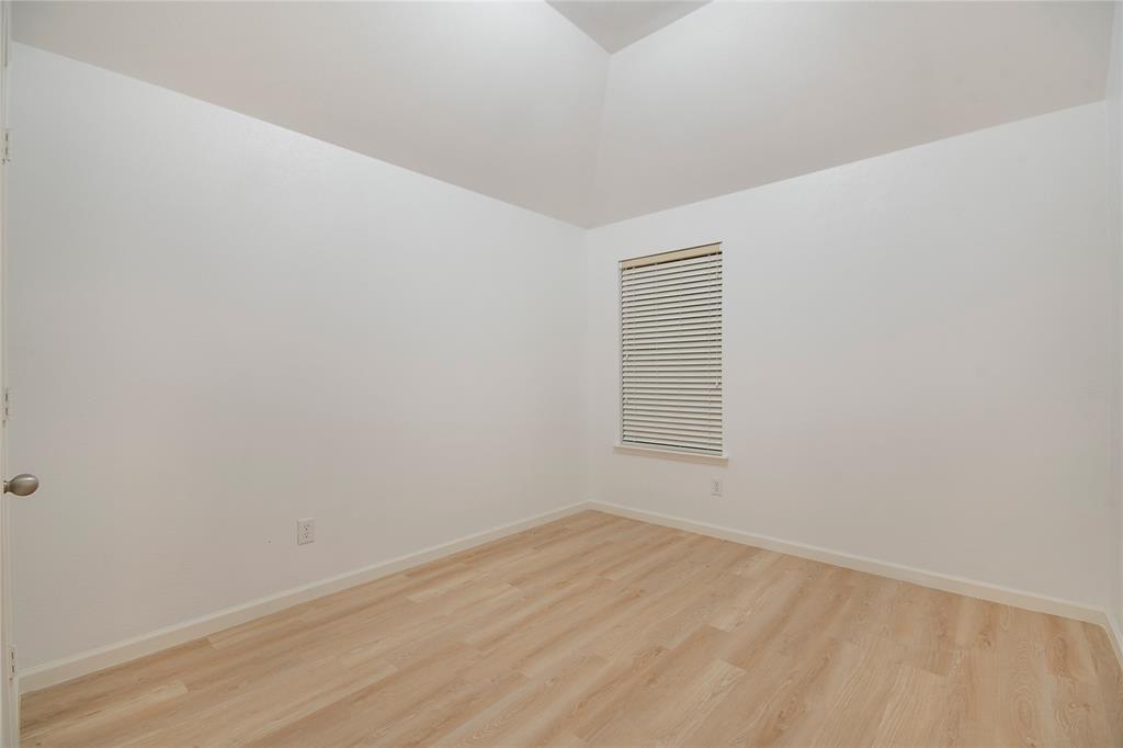549 Hickory Lane Fate, TX 75087 - Photo 27 of 38 Empty room featuring light wood-style floors and lofted ceiling