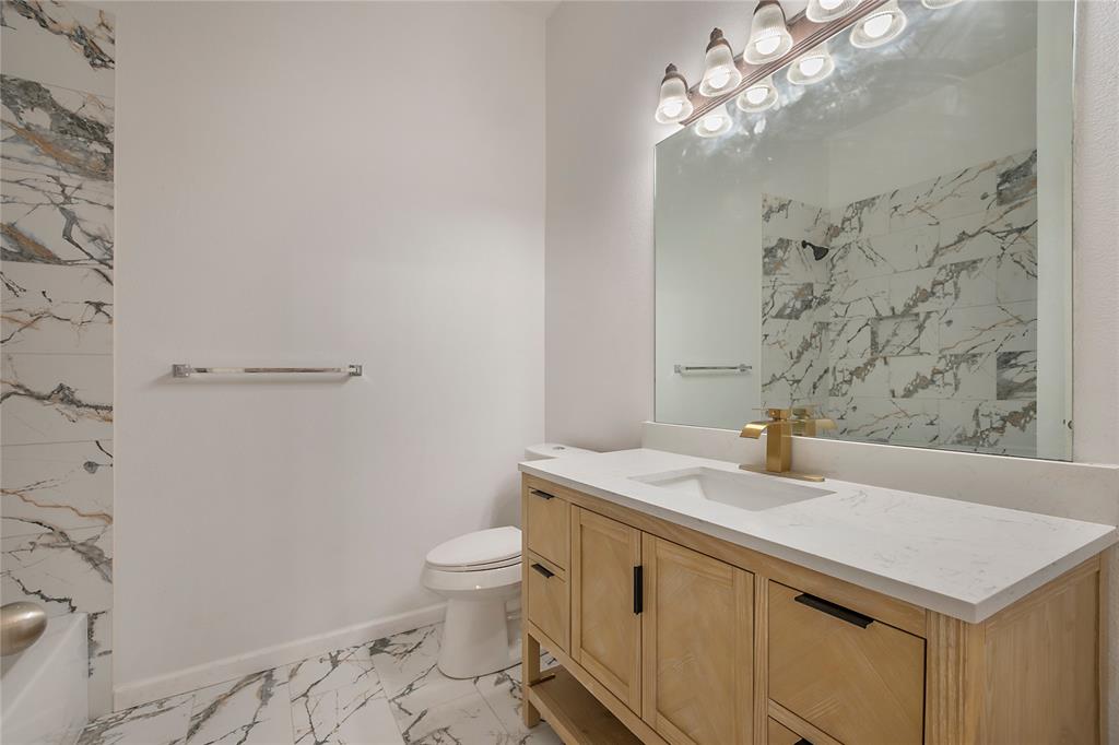 549 Hickory Lane Fate, TX 75087 - Photo 30 of 38 Full bath featuring vanity and light marble finish flooring