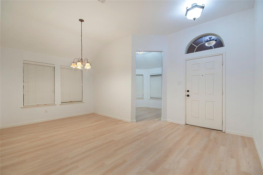 549 Hickory Lane Fate, TX 75087 - Photo 3 of 38 Entryway with light wood-style floors, suspended lighting, and vaulted ceiling