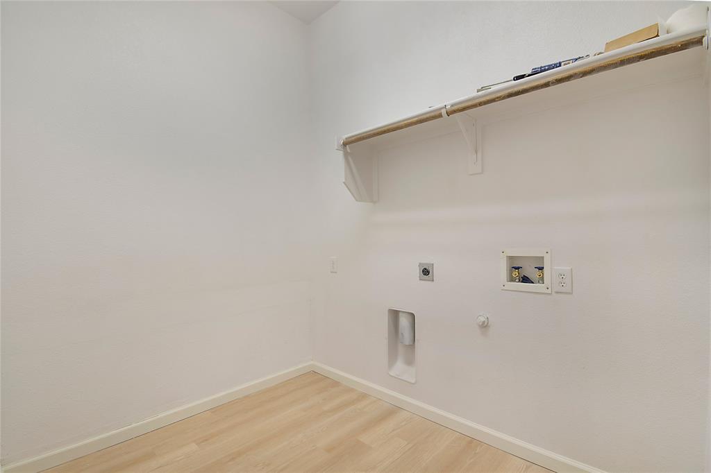 549 Hickory Lane Fate, TX 75087 - Photo 32 of 38 Laundry room featuring gas dryer hookup, hookup for an electric dryer, light wood-style flooring, and hookup for a washing machine