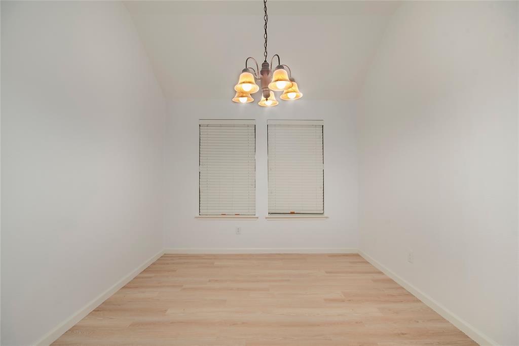 549 Hickory Lane Fate, TX 75087 - Photo 6 of 38 Unfurnished dining area with suspended lighting, light wood-type flooring, and vaulted ceiling