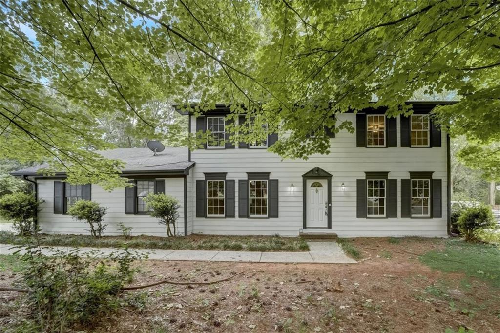a front view of a house with a garden