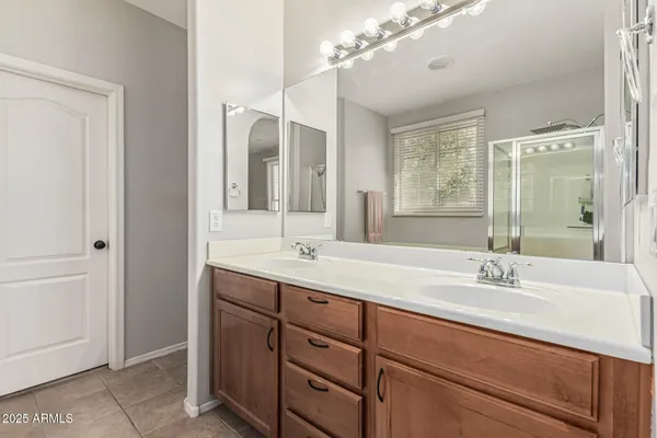 a bathroom with a sink double vanity and a mirror